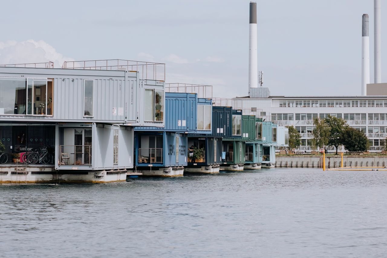 Services-03 Innovative container homes on water, showcasing modern urban living in Copenhagen's harbor.